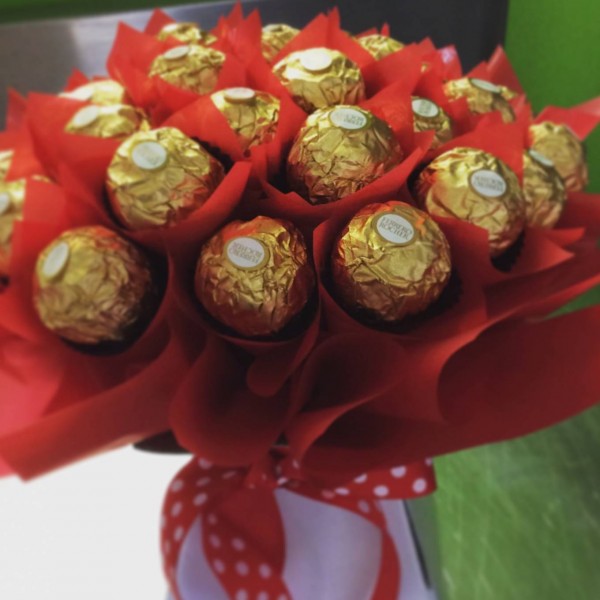a chocolate bouquet made of 30 ferrero rocher chocolates wrapped in in red cellophane.