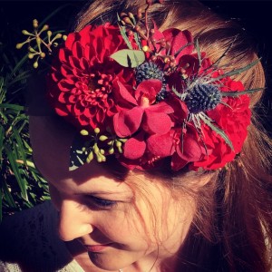 a floral headpiece made using red dahlias and orchids