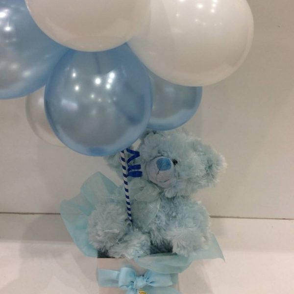 a cluster of blue and white balloons with a blue fluffy teddy