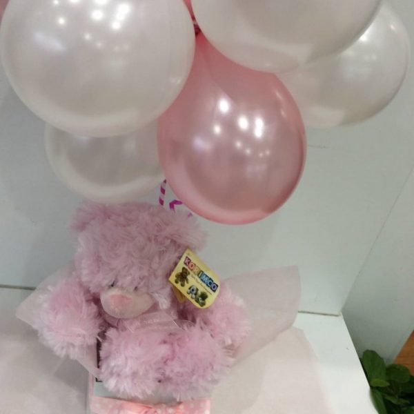 a cluster of 12 small balloons in pink and white with a pink fluffy teddy bear.