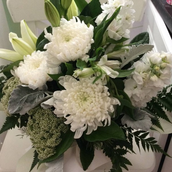 a simple white and green arrangement in a box