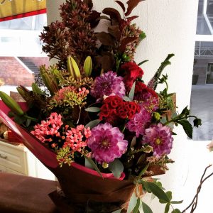 a large front facing bouquet of seasonal flowers in rich, warm tones.