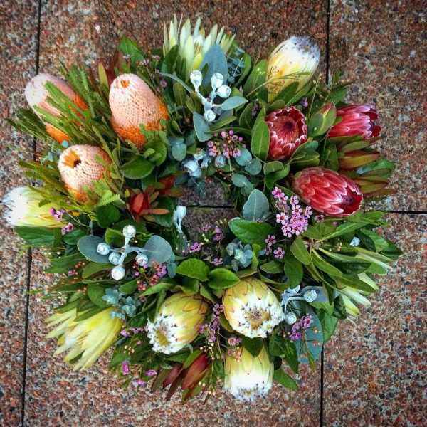 a large fresh wreath made using wildflowers.