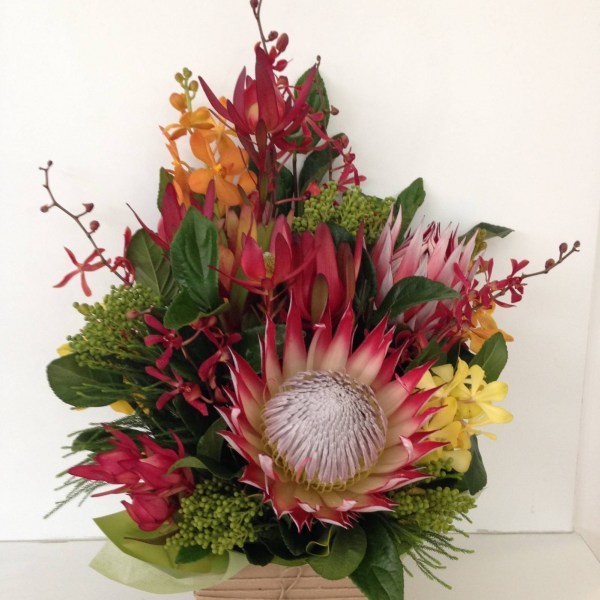 a box arrangement using native wildflowers and foliages with other seasonal flowers. earthy colours.