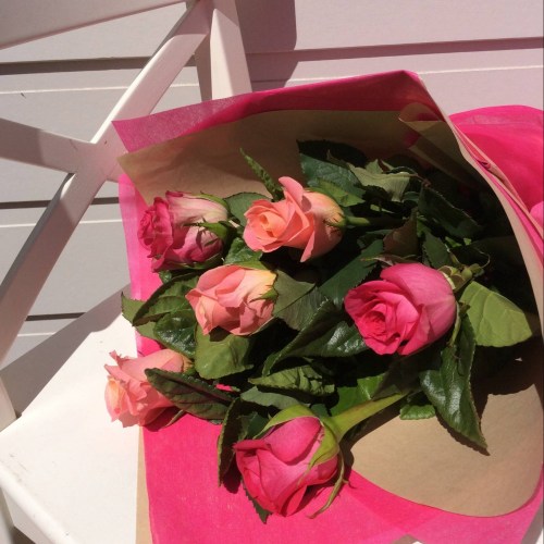 a hand tied bouquet of 6 pink roses, wrapped in neutral and pink paper and hessian.- A Touch of Class Florist