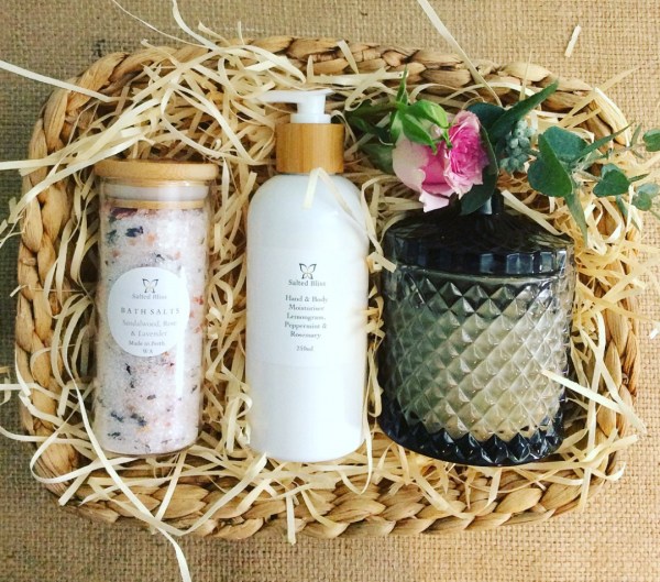 Relax and Enjoy Pamper Hamper contains a Salted Bliss Bath Salt, A Salted Bliss Hand and Body Cream and a Bear and Finn Scented Soy Candle packaged in a seagrass basket - A Touch of Class Florist