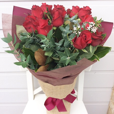 A Beautifully hand-tied red rose bouquet