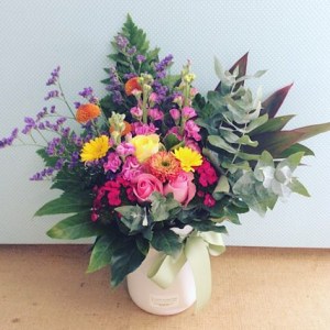 Ceramic vase arrangement in Seasonal Brights, White ceramic vase filled with the seasons best bright blooms - A Touch of Class Florist Perth
