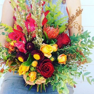 Rustic Posy Hand-tied Bouquet is a short but full posy of reds, oranges, bugundy and a hint of white blooms - A Touch of Class Florist