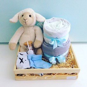 Little Lamb Baby Hamper in Blue includes Sophie Sheep from Nana Huchy, 2 x baby wraps, newborn nappies, Sated Bliss Bath Salts, 2 items of baby clothing all wrapped up in a rustic wooden crate - A Touch of Class Florist