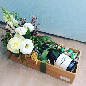 Just For You Christmas Edition includes a small arrangement of fresh flowers, a bottle of sparkling wine and some festive chocolates all wrapped up in a bamboo tray - A Touch of Class Florist