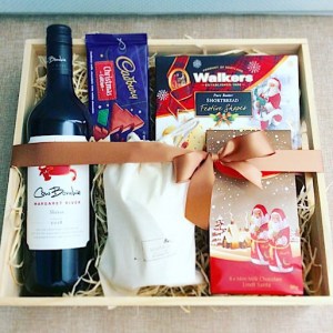 Night Before Christmas Hamper includes a selection of Christmas goodies, a bottle of wine, and a Bear and Find hand poured soy candle - A Touch of Class Florist