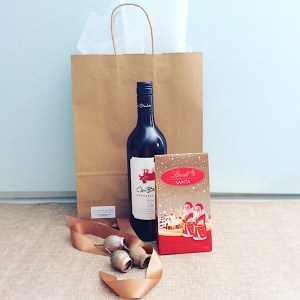 Secret Santa Hamper is for when you just want to send a little Festive Cheer. Includes a bottle of wine and some festive chocolates - A Touch of Class Florist