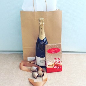 Secret Santa with sparkles includes a bottle of sparkling wine and some festive chocolates - A Touch of Class Florist