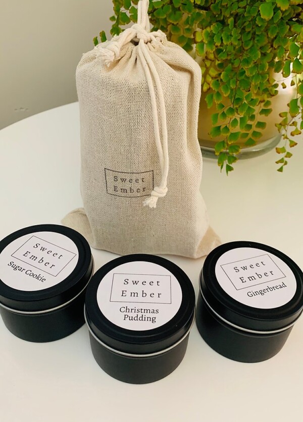 Sweet Ember Christmas Set contains three mini festive scented candles in black tins packaged in a natural calico bag.
