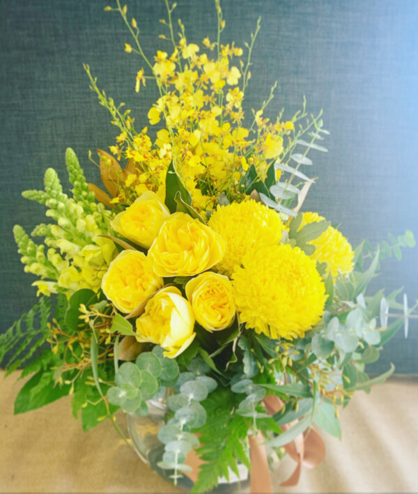 Seasonal Fishbowl in Yellow by A Touch of Class florist is a vibrant arrangement of seasonal blooms in yellow tones. Arranged into a glass fishbowl vase. By A Touch of Class Florist Perth
