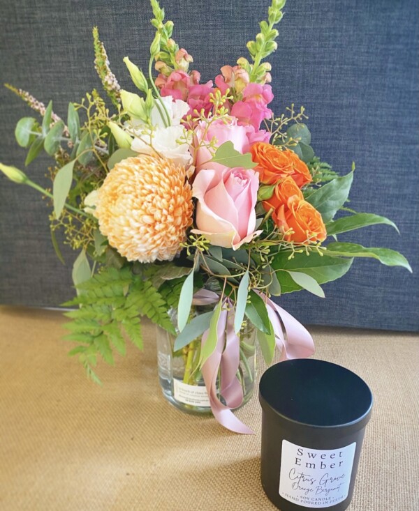 Gift For You Black by A Touch of Class Florist Perth includes as seasonal jam jar of fresh flowers and a Sweet Ember candle, scent will vary, in a black jar with a black lid.